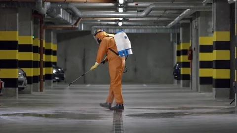 Frontline Worker in Full Hazmat Suit Disinfects Coronavirus Contaminated Car Stock Footage 129199270