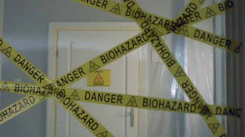 Frontline Worker in Full Hazmat Suit Enters Coronavirus Contaminated Room Stock-Footage 129199574