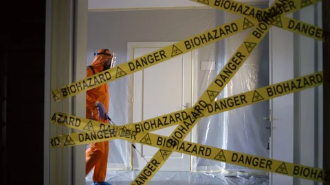 Frontline Worker in Full Hazmat Suit Enters Coronavirus Contaminated Room Stock Footage 129199810