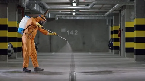 Frontline Worker in Full Hazmat Suit Disinfects Coronavirus Contaminated Car Stock-Footage 129199890