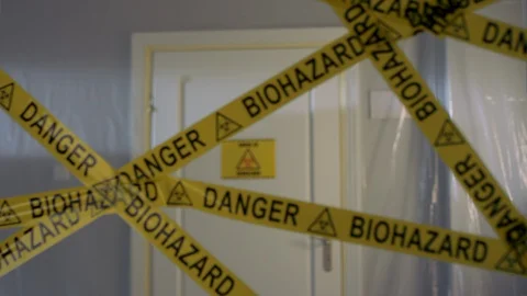 Frontline Worker in Full Hazmat Suit Enters Coronavirus Contaminated Room Stock-Footage 129199996