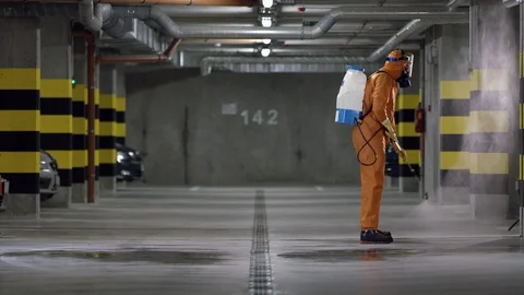 Frontline Worker in Full Hazmat Suit Disinfects Coronavirus Contaminated Car Stock-Footage 129202305