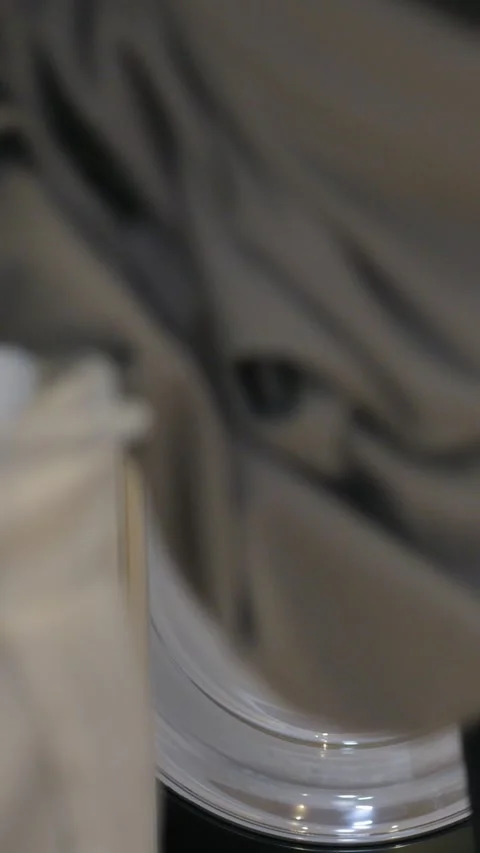 Frontload washing machine drum caucasian woman loads clothes, closeup door view Stock-Footage 344720322