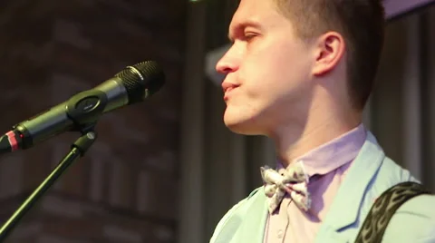 Frontman at the microphone with a guitar Stock Footage 40451089
