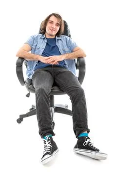 Frontview of lazy man sitting stretched out in an armchair Stock Photos