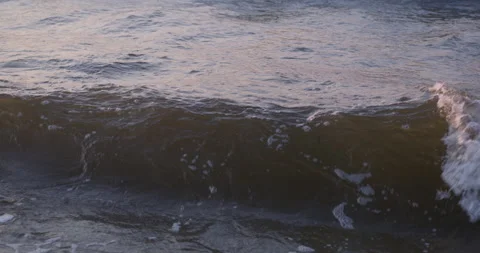 Frontview of the surging sea waves splashing at sunset Stock-Footage 248447556