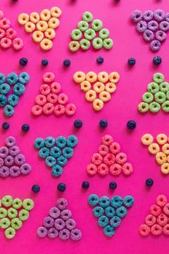 Froot loops in the shape of a triangle blue, green, purple, pink, orange on a 写真素材