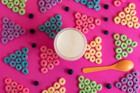 Froot loops in the shape of a triangle blue, green, purple, pink, orange on a Stock Photos