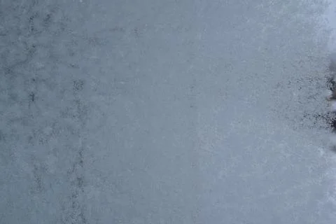 Frost and ice crystal pattern on window glass close up Stock Photos