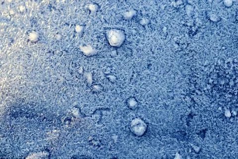 Frost on the blue surface. Stock Photos