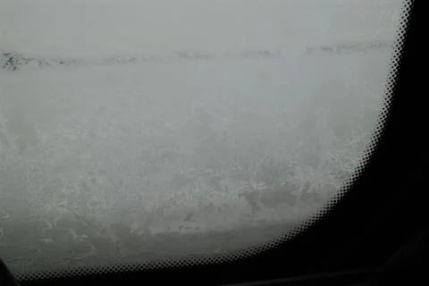 Frost covered car windshield on a cold winter day Stock Photos