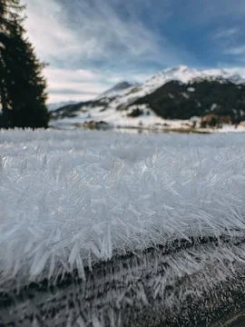 Frost covering surface with mountain in background on sunny winter day Stock-Fotos