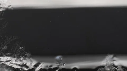 Frost draws a magic pattern on the glass Stock Footage 104476712