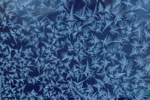 Frost draws: a pattern of different elements on the window glass on a frosty  Stock Photos