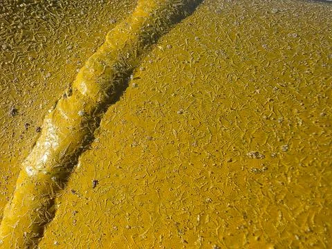 Frost Forms on Yellow Pipe in Winter Scene Shining Under Sunlight 写真素材