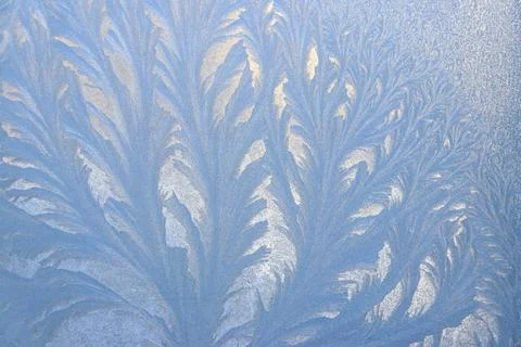 Frost pattern on a frozen window at winter. Natural background, texture Stock Photos