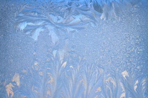 Frost pattern on a frozen window at winter. Natural background, texture Stock Photos