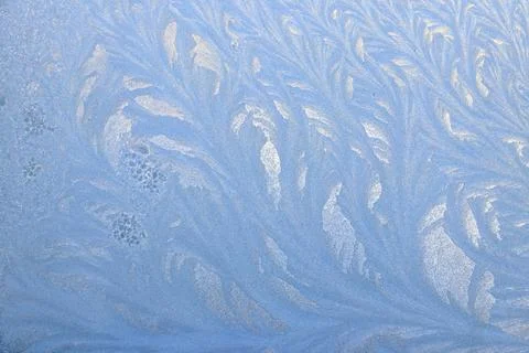 Frost pattern on a frozen window at winter. Natural background, texture Stock Photos