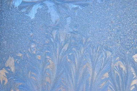 Frost pattern on a frozen window at winter. Natural background, texture Stock Photos