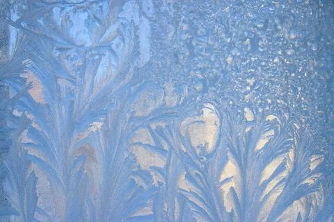 Frost pattern on a frozen window at winter. Natural background, texture Stock Photos