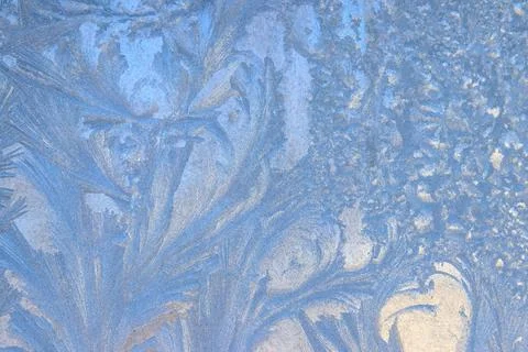 Frost pattern on a frozen window at winter. Natural background, texture Stock Photos