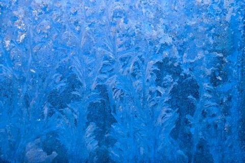 Frost pattern on a frozen window at winter. Natural background, texture Stock Photos