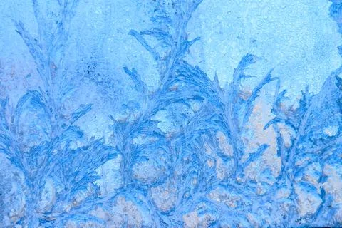 Frost pattern on a frozen window at winter. Natural background, texture Stock Photos