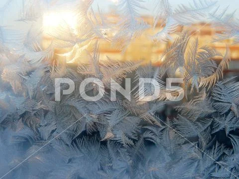 Frost Pattern on Window Glass in Sunlight Stock Photos