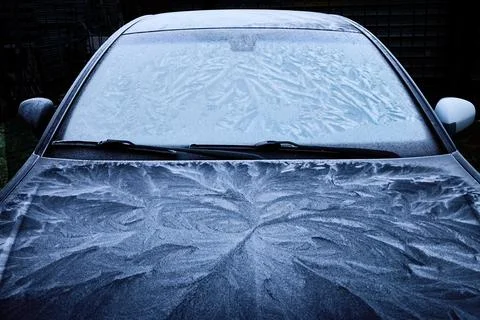 Frost Patterns on Car. A car covered in intricate frost patterns on a cold Stock Photos