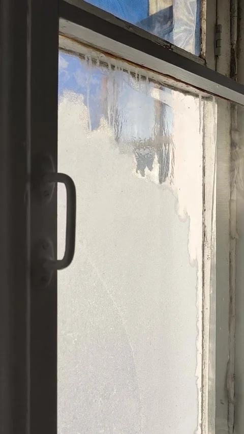 Frost patterns, drops of water and condensation on the glass of an old wooden Video stock 326734732