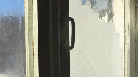 Frost patterns, drops of water and condensation on the glass of an old wooden Stock Footage 326734927