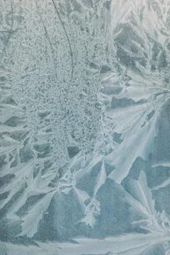 Frost patterns form delicate, crystalline structures on a cold surface Stock Photos