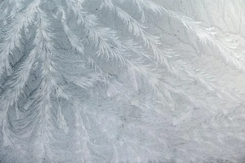 Frost patterns on glass at subzero temperatures, abstract winter pattern Stock Photos