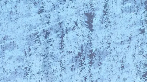 Frost patterns on glass window surface. Abstract winter background. Video stock 301712573