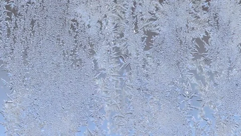 Frost patterns on glass window surface. Abstract winter background. Stock Footage 301713892