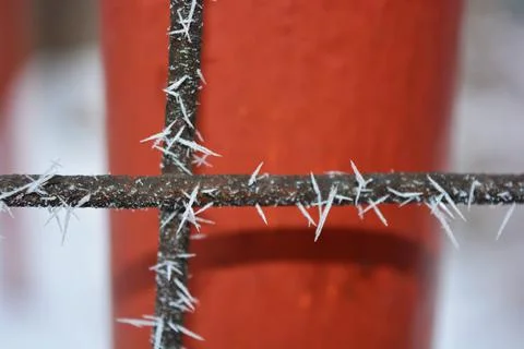 Frost, white snowflakes with sharp corners glued to the dark old metal. 写真素材