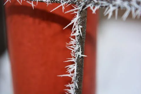 Frost, white snowflakes with sharp corners glued to the dark old metal. 写真素材