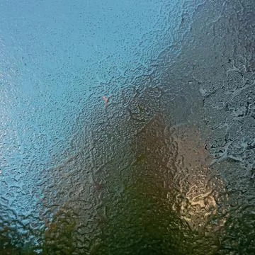 Frost on the windshield, the rays of the morning sun melt the frost formed Stock Photos