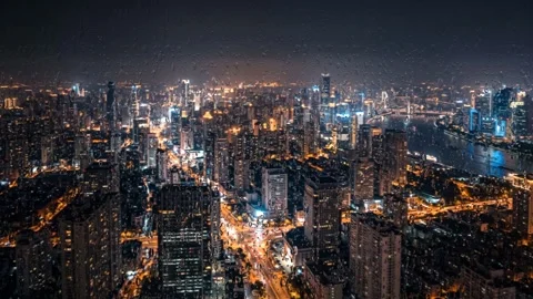 Frosted aerial perspective of a massive glowing city at night. 4K Stock Footage 343244259