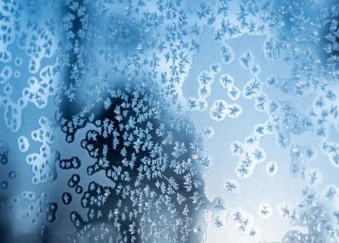 Frosted blue surface with intricate patterns and textures reflecting light in a 스톡 사진