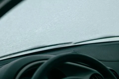 Frosted car windshield covered in ice and snow Stock Photos