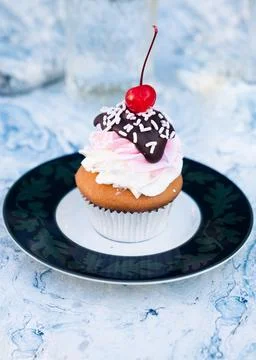 Frosted cupcake with cherry on top Stock Photos