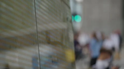 Frosted glass panel at urban transit stop, blurred city life behind Stock-Footage 337647978