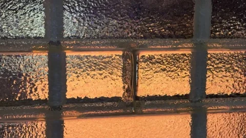Frosted Glass Panel with Warm Yellow Light Glowing Through Soft Texture 動画素材 332033094