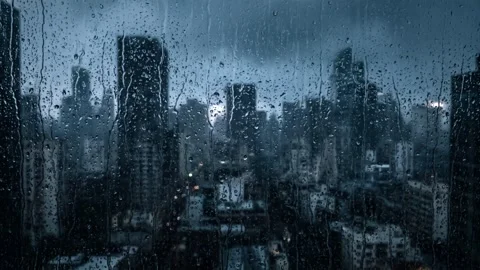 Frosted glass with raindrops overlooking a dark city skyline. 4K Video stock 343244102