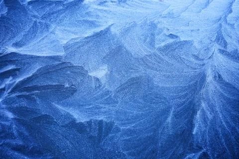 Frosted Patterns. Close-up of intricate icy frost patterns on a surface Stock Photos