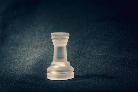 Frosted Rook chess piece on dramatic background Stock Photos