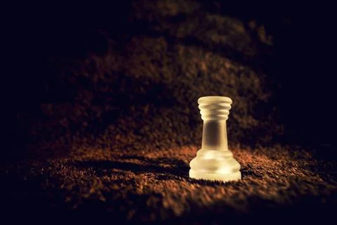 Frosted Rook chess piece on dramatic background Stock Photos