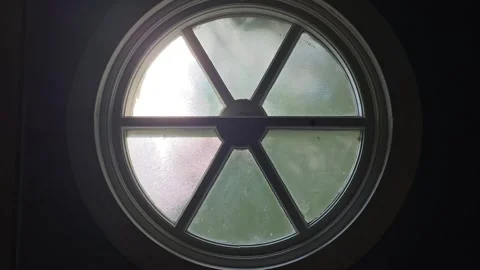 Frosted round window with sunlight coming through abstract background video Stock Footage 325889736