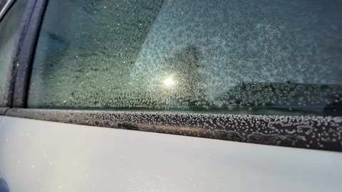 Frosty Car Window Reflecting Sunrise Stock Footage 305088931